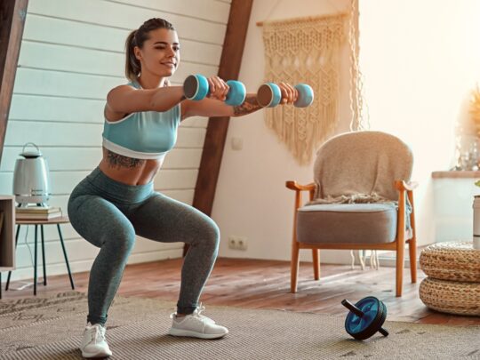 A young woman does her fitness workout at home